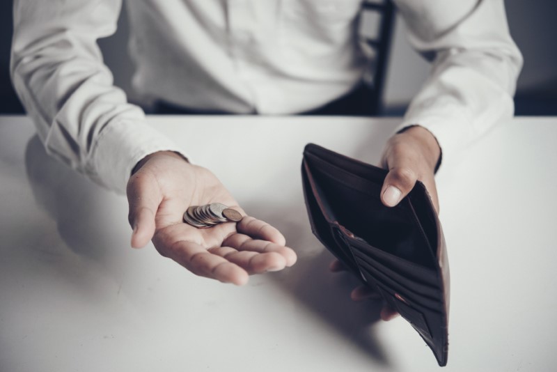 businessman saving money,Man carrying a wallet in hand, the doll